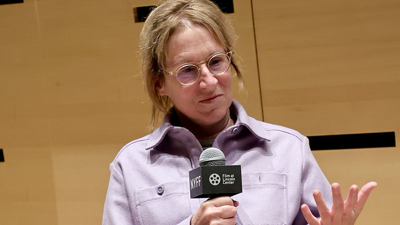 Kelly Reichardt holding microphone