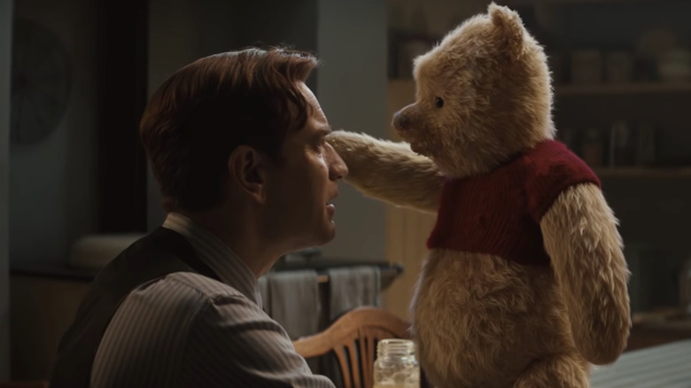 Live-action Christopher Robin holds Pooh