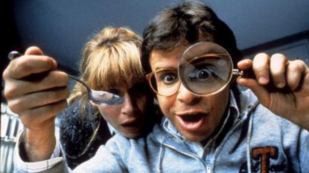 Rick Moranis with magnifying glass