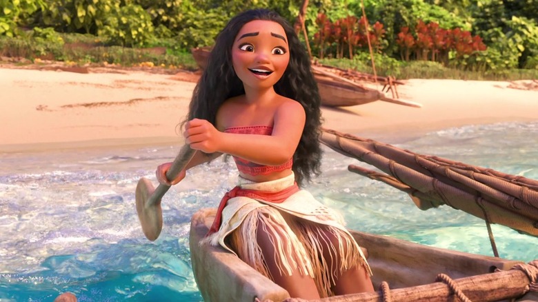 Moana smiling and paddling canoe