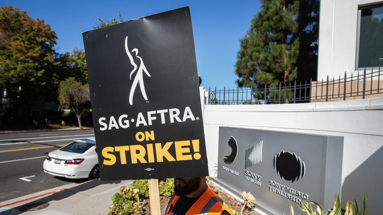 A man holds a picket sign