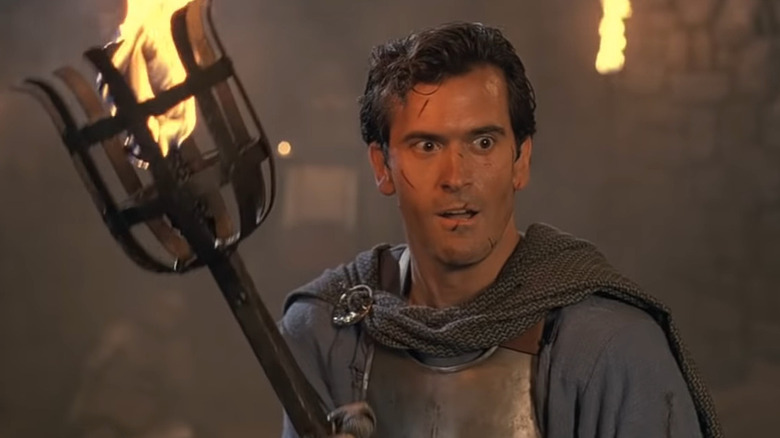 Bruce Campbell with a torch