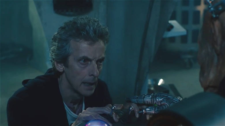 The 12th Doctor holds Davros' hands 