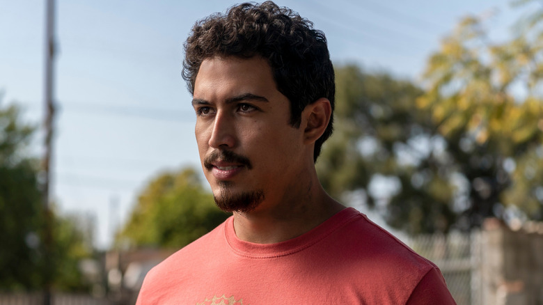 Oscar stands outside in a red shirt in "On My Block" (2018-2021)