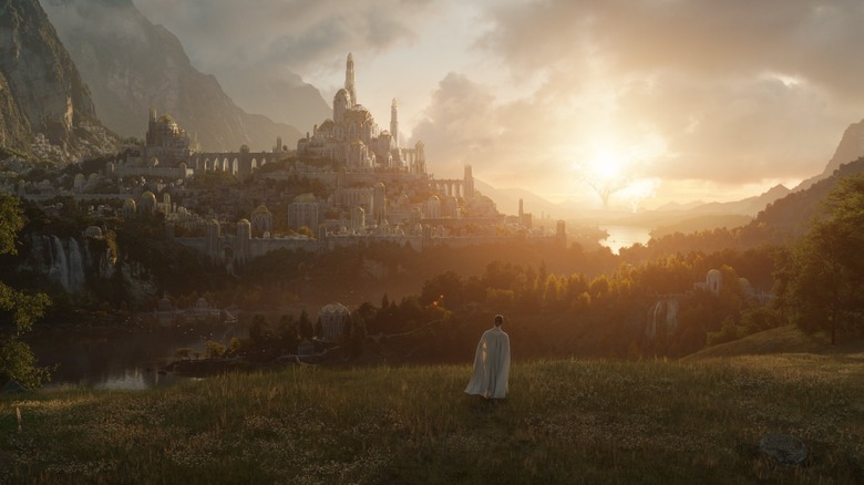 Middle Earth man stands on hill looking at city