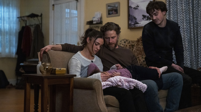 Ben Stone sits on the couch with his family