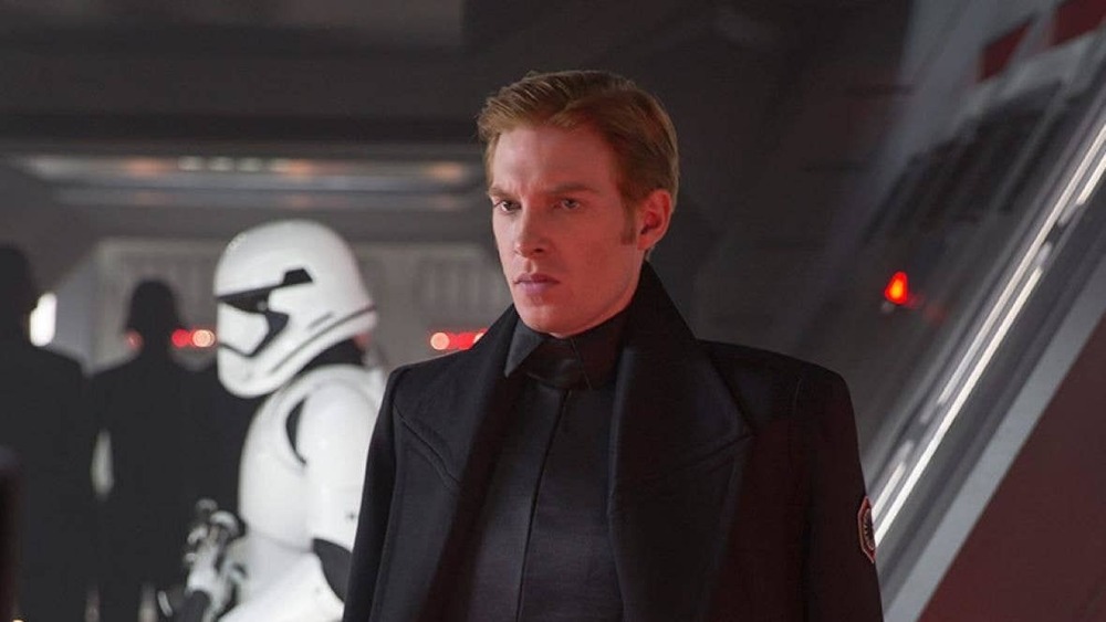 Hux looking surly next to a Storm Trooper