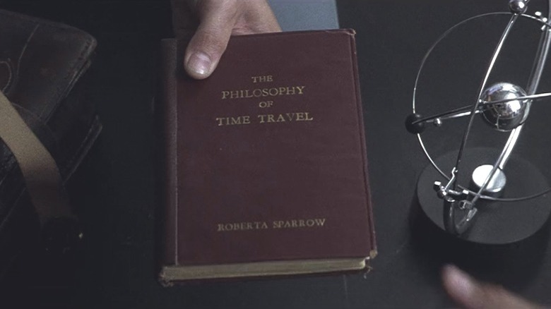 Hand holds time travel book