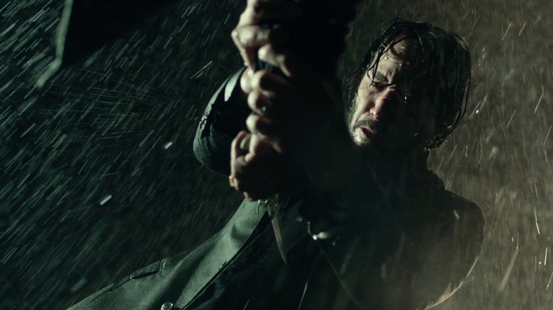 Keanu Reeves John Wick pointing gun rain