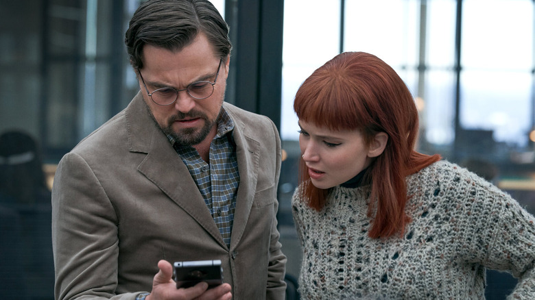 Dr, Mindy and and Kate Dibiasky looking at phone