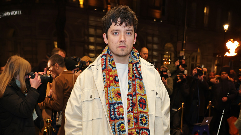 Asa Butterfield looking somber