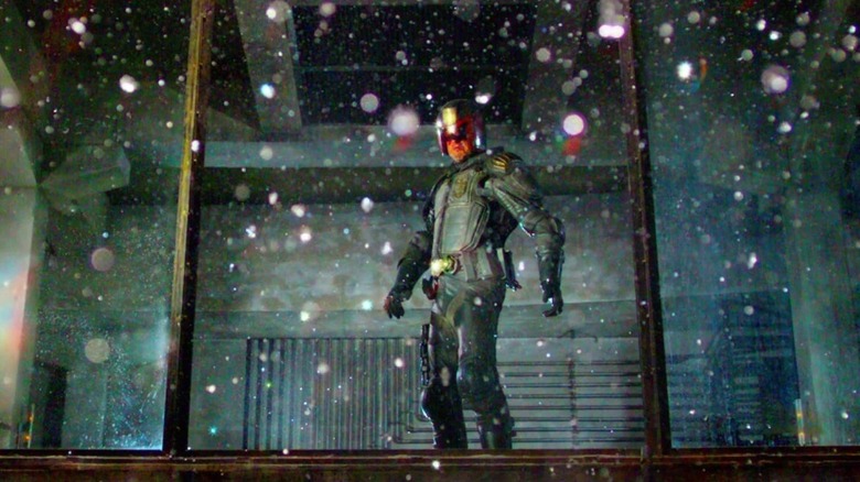 Dredd looks out a broken window