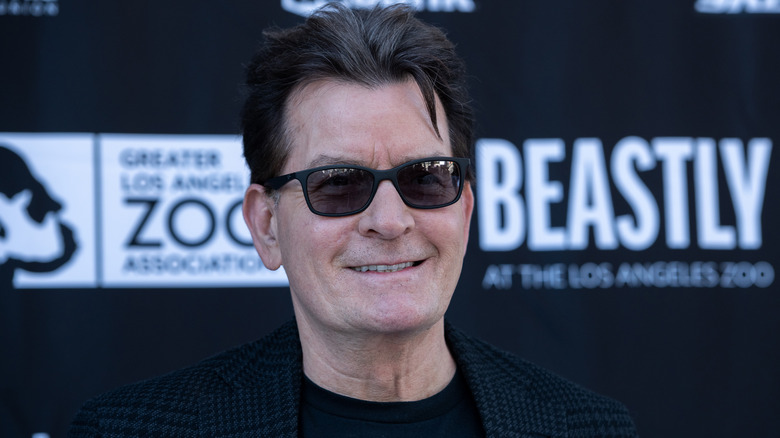 Charlie Sheen smiling in sunglasses