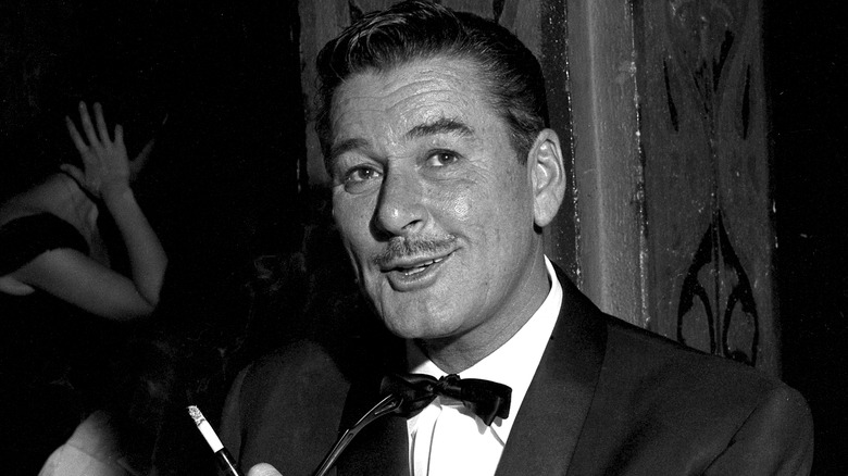 Errol Flynn smoking wearing tuxedo