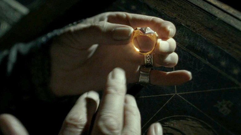 Dumbledore puts on Marvolo Gaunt's ring in Harry Potter