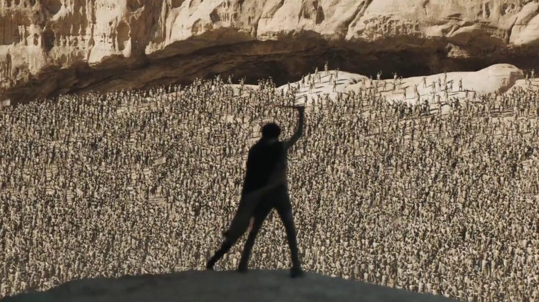 Paul Atreides holding a Fremen knife above his head and rallying a Fremen army in Dune Pt. II (2024)