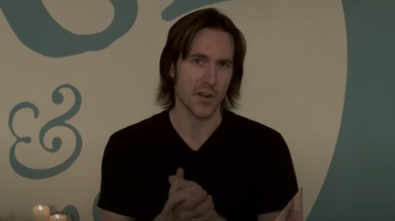 Matt Mercer talking in front of a Geek and Sundry backdrop 