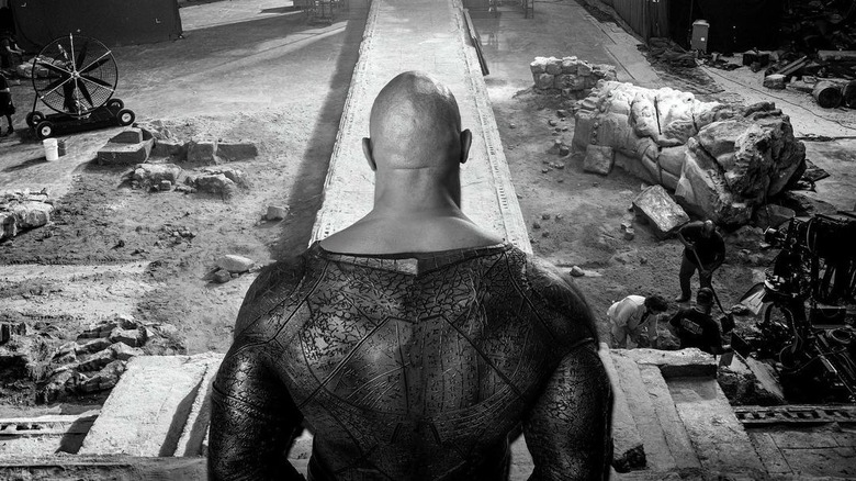 Black Adam standing amongst ruins