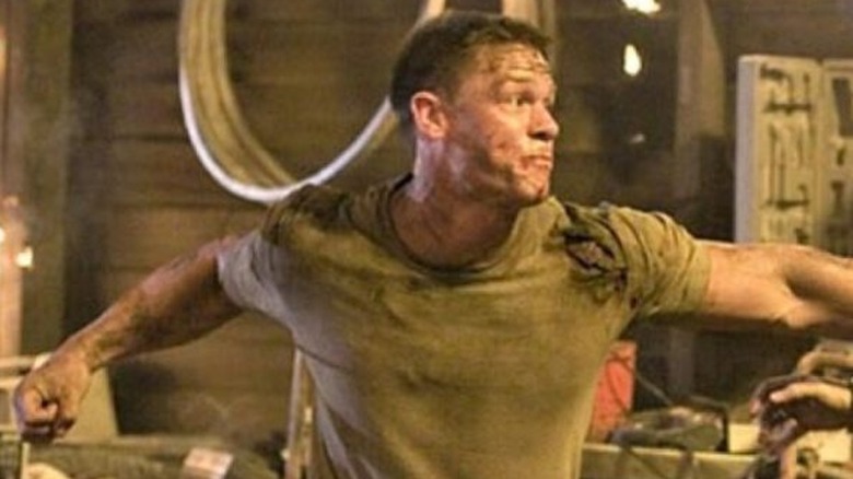 A bloodied John Cena throws a punch