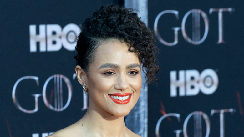 Nathalie Emmanuel smiles and wears her hair up