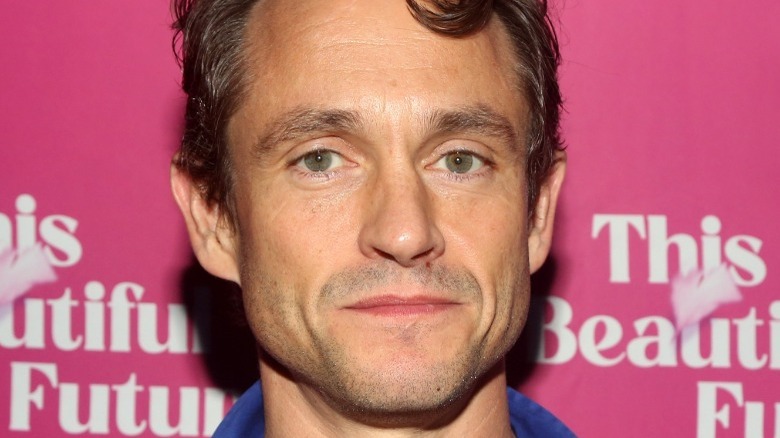 Hugh Dancy poses at a premiere