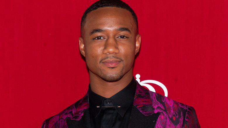 Jessie T. Usher in pink patterned suit