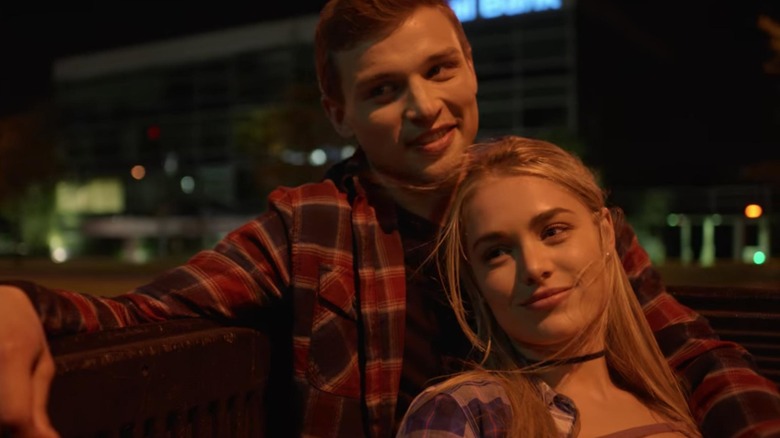 Shane and Rachel sit in the back of a truck