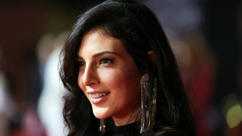 Razane Jammal smiles at a red carpet event