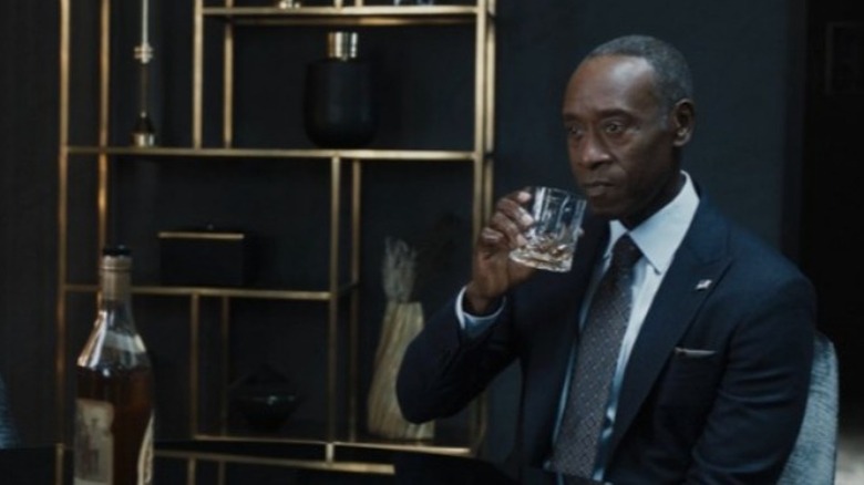 Rhodey drinking bourbon