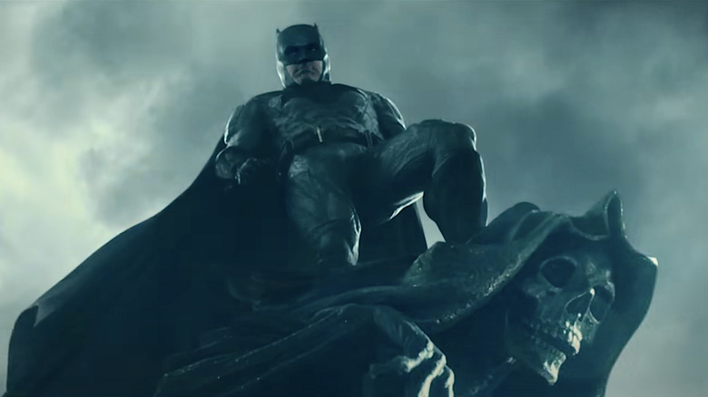 Batman standing on gargoyle