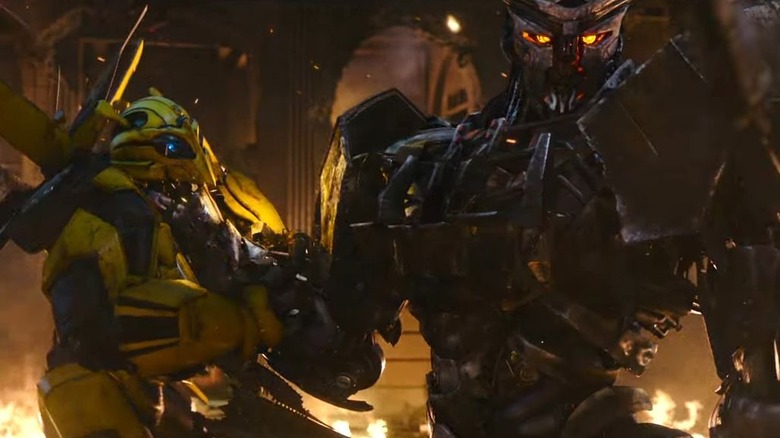 Scourge holding up Bumblebee