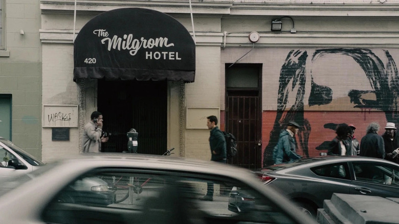 Scott walks towards the Milgrom Hotel