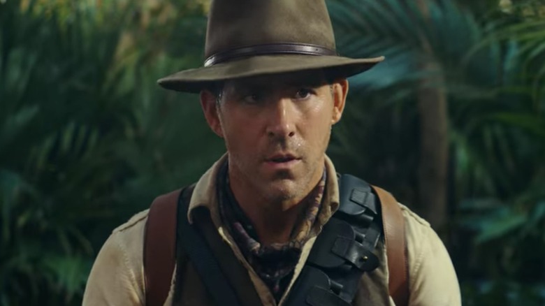 Booth wearing a fedora in the jungle