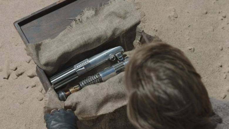 Obi-Wan digging up lightsabers