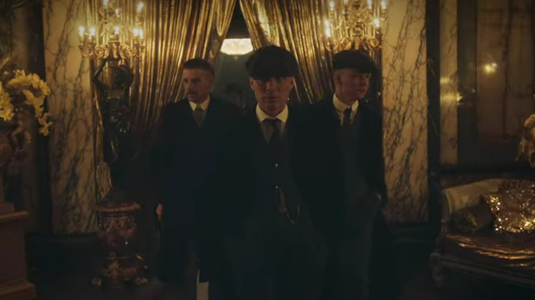 Cillian Murphy as Tommy Shelby entering a club with gold curtains