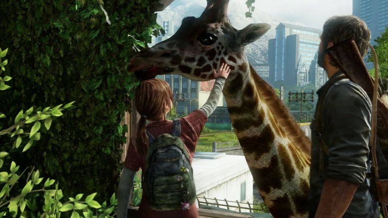 Ellie and Joel petting a giraffe