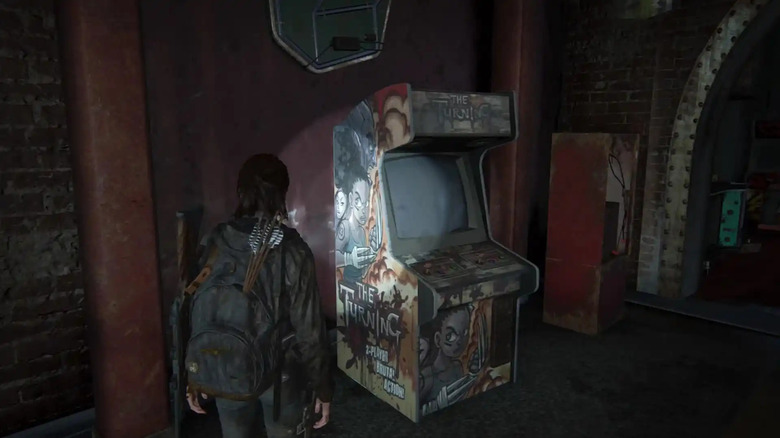 Ellie looking at an non-working The Turning game in an arcade