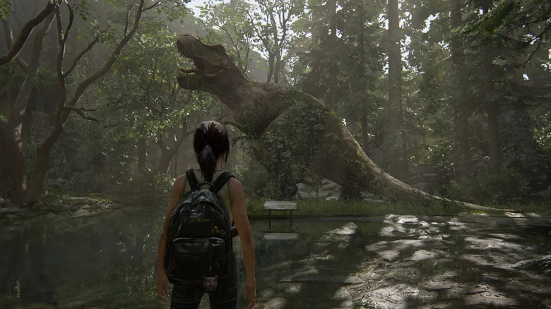 Ellie looking at a T-Rex statue