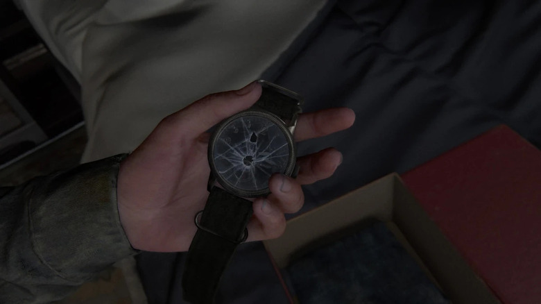 Ellie holding Joel's broken watch in his bedroom