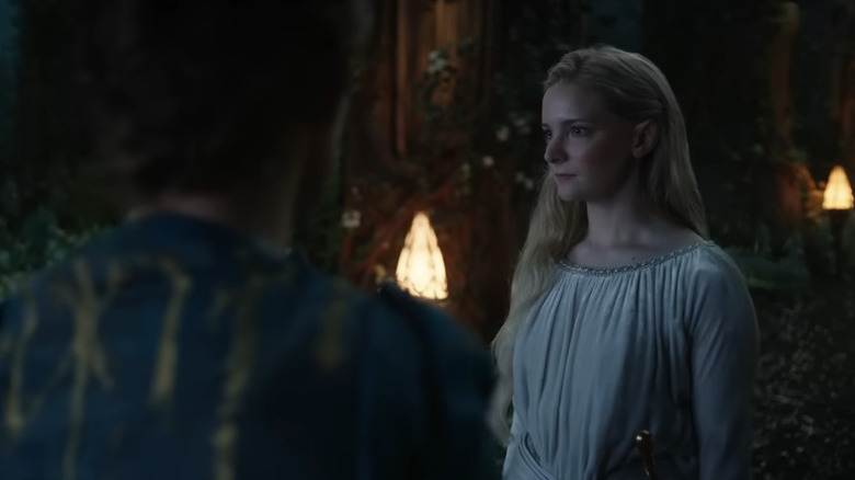 Galadriel talking amidst statues