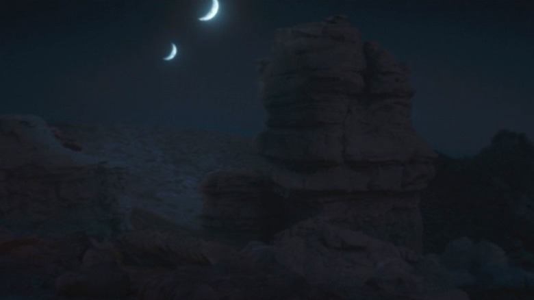 Twin moons rise over the desert