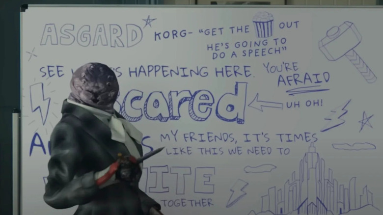 Miek takes notes on a dry erase board