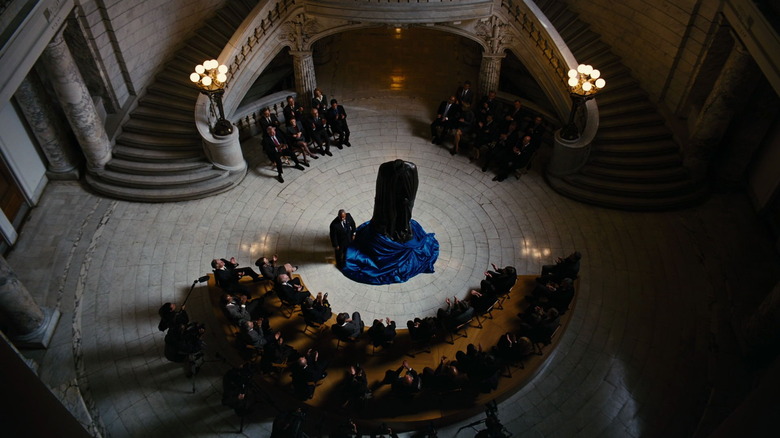 Batman statue unveiled, chairs and table arranged in a smile