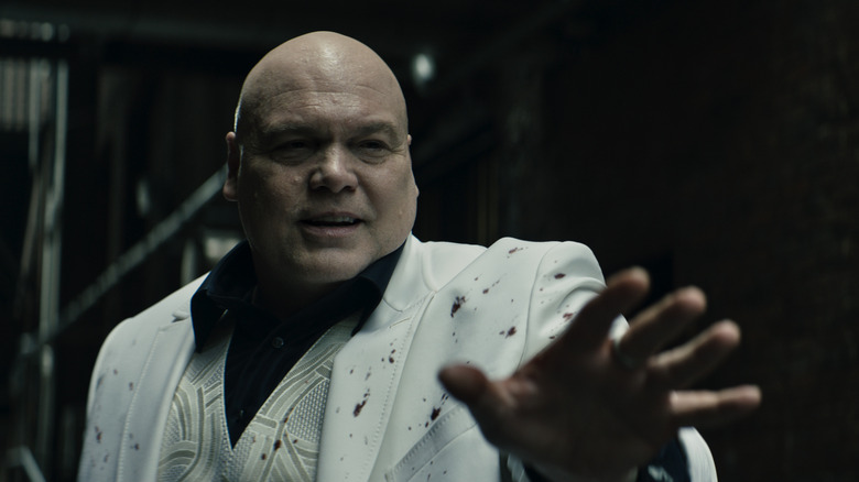 Kingpin holding out hand 