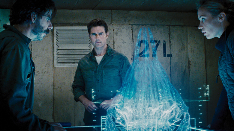 Carter, Cage, and Vrataski look at a hologram of Omega