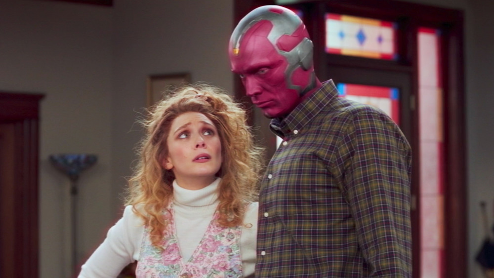 Wanda looking up at Vision, in '80s outfits