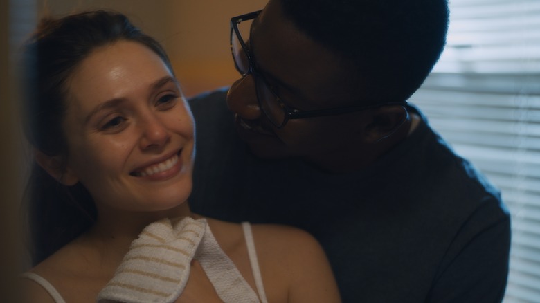 Elizabeth Olsen and Mamoudou Athie embrace