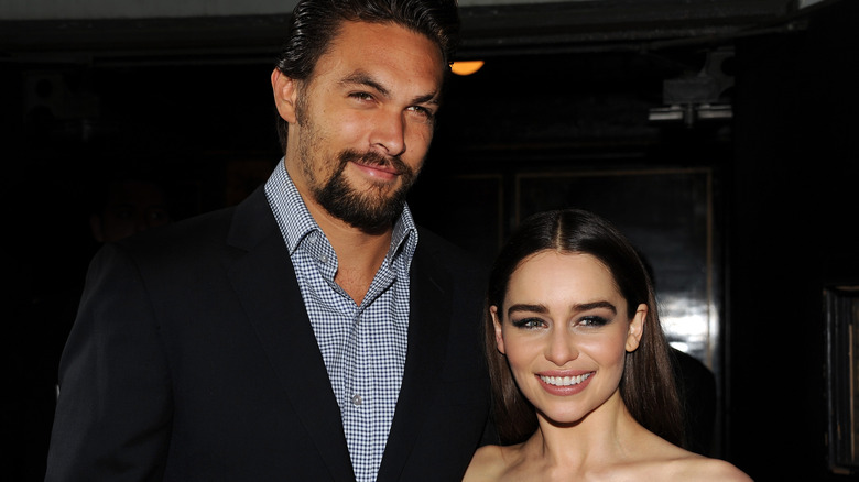 Emilia Clarke and Jason Momoa smiling