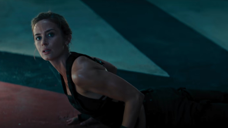 Rita doing pushups and looking up in Edge of Tomorrow