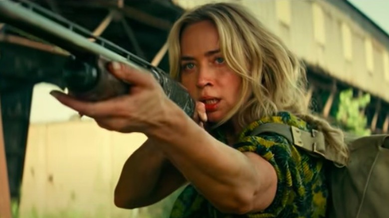 Emily Blunt Evelyn Abbott aiming shotgun